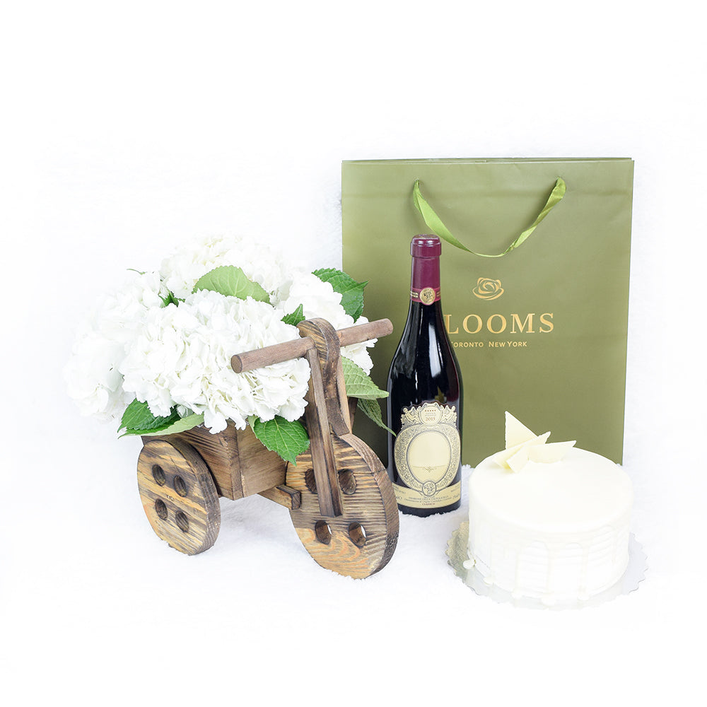 A Lovely Celebration Flowers &amp; Wine Gift, Hydragea Flower in a wooden bicycle planter with Wine and Cake, from Vancouver Blooms - Same Day Vancouver Delivery.