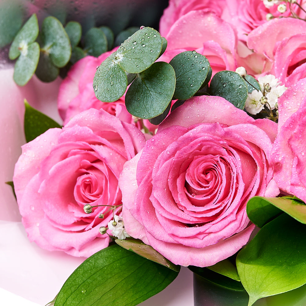 The Complete Pink Rose & Wine Gift Set, a selection of pink roses and greens gathered into a floral wrap and tied with ribbon and presented in a flower box alongside two bottles of wine and a box of chocolate truffles, Floral Gifts from Vancouver Blooms - Same Day Vancouver Delivery.