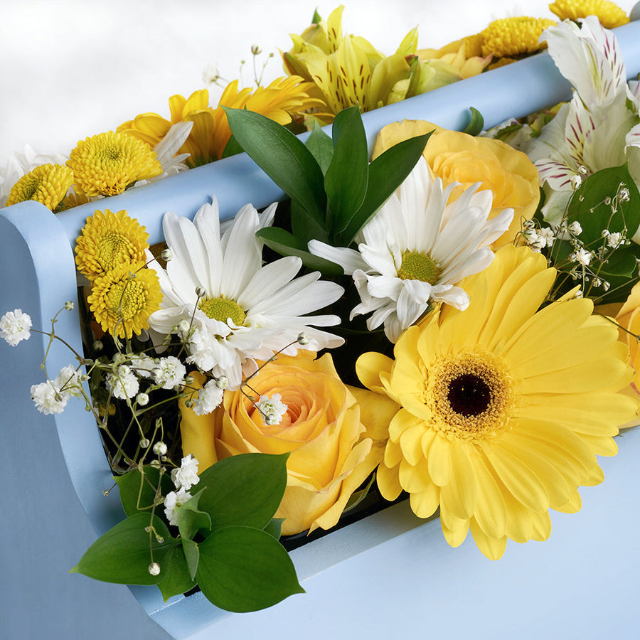 Yellow and white mixed floral arrangement in a blue toolbox. Same Day Vancouver Delivery