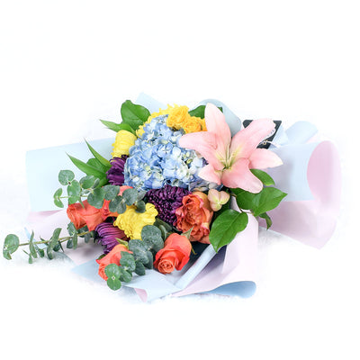 The Festive Purim Bouquet from Vancouver Blooms features a cheerful arrangement of roses, cremons and other flowers tied with a designer ribbon