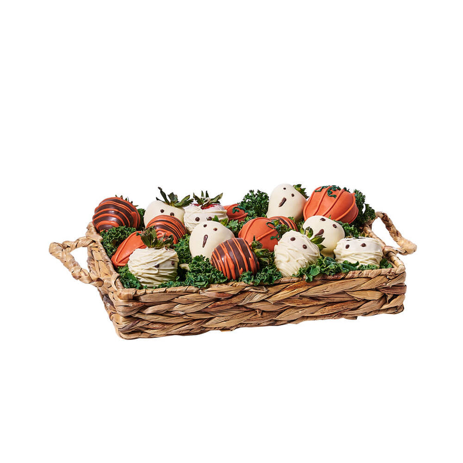 Ghostly Chocolate Covered Strawberry Tray, variety of Halloween chocolate-covered strawberries adorned in brown, orange, and white chocolate with seasonal designs. Presented in a woven basket tray, Holiday Gifts from Vancouver Blooms - Same Day Vancouver Delivery.