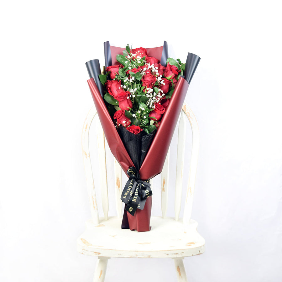 This bouquet includes a selection of deep red roses, baby’s breath, and ruscus gathered in floral wrap with designer ribbon. Blooms Vancouver- Blooms Vancouver Delivery