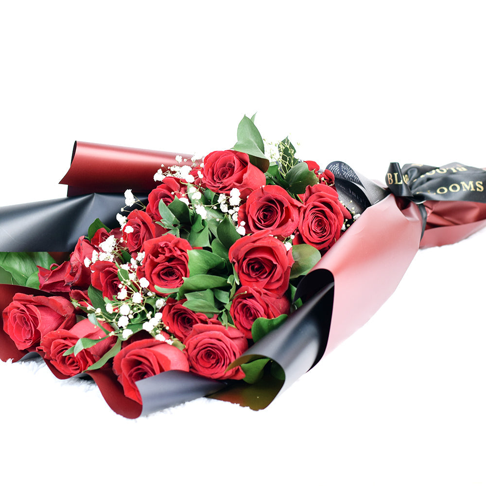 This bouquet includes a selection of deep red roses, baby's breath, and ruscus gathered in floral wrap with designer ribbon. Blooms Vancouver- Blooms Vancouver Delivery